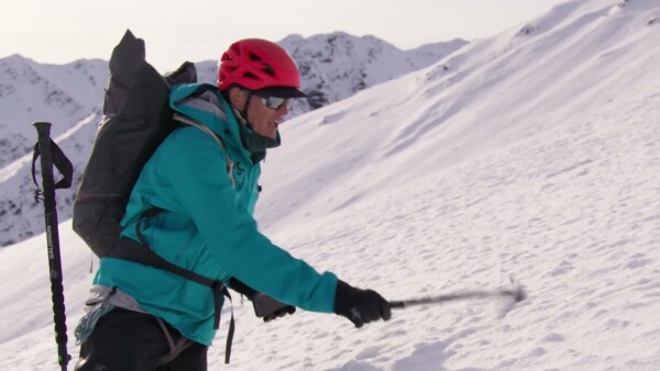Mountaineer showing with an ice axe who to determine angle