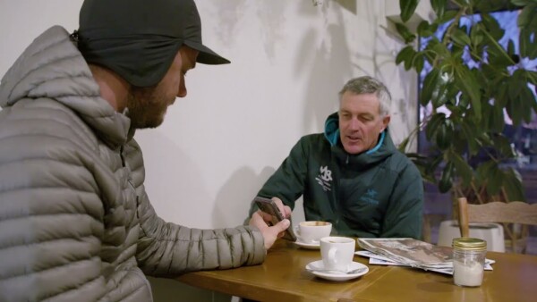 2 alpinist discussing a danger rose over coffee in a cafe
